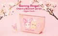 A pink zipper pouch with cherry blossom patterns and cartoon characters, including a Sonny Angel minifigure.